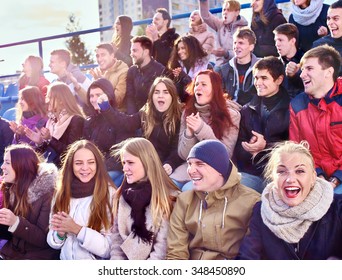 Sport Fans Clapping And Singing On Tribunes. Group Happy Young People.