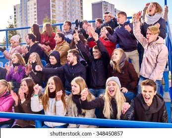 Sport Fans Hands Up Clapping And Singing On Tribunes. Group People.