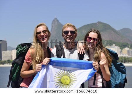 Sport fans holding Argentina Flag in Rio de Janeiro with Christ the Redeemer in background.