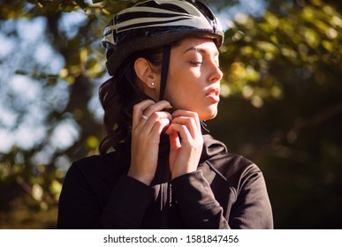 Sport female cyclist adjust helmet on head - Powered by Shutterstock