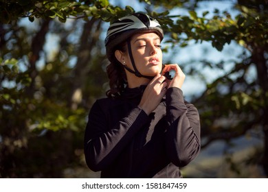 Sport female cyclist adjust helmet on head - Powered by Shutterstock