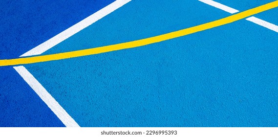 Sport field court background. Blue rubberized and granulated ground surface with white, yellow lines on ground. Top view