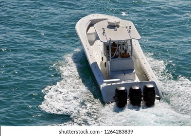 Sport fishing boat powered by three outboard meninges cruising on the Florida Intracoastal Waterway off Miami Beach.