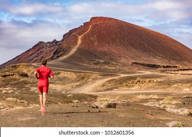 Sport And Fitness Athlete Running On Mountain Trail, Man Active Lifestyle. Man Runner On Long Distance Run Through Desert Summer Landscape.