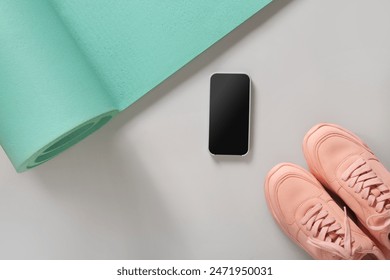 Sport and fitness equipment, black dumbbells, smartphone, pink fitness sneakers shoes for fun activity workout on gray background. View from above, copy space. - Powered by Shutterstock