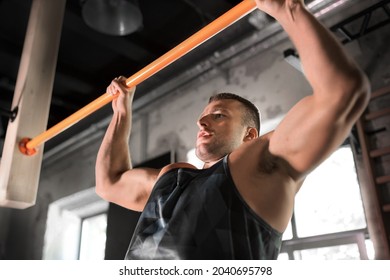 sport, fitness, exercising and people concept - man doing pull-ups on horizontal bar in gym - Powered by Shutterstock