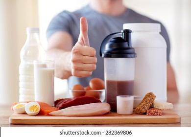 Sport, Fitness, Healthy Lifestyle, Diet And People Concept - Close Up Of Man With Food Rich In Protein Showing Thumbs Up