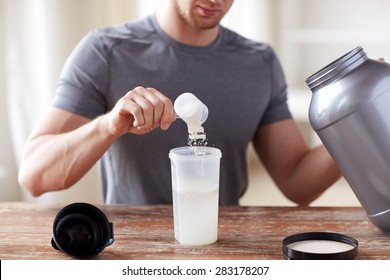 sport, fitness, healthy lifestyle and people concept - close up of man with jar and bottle preparing protein shake - Shutterstock ID 283178207