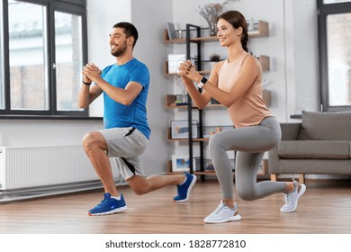 Sport, Fitness, Lifestyle And People Concept - Smiling Man And Woman Exercising And Doing Squats In Low Lunge At Home