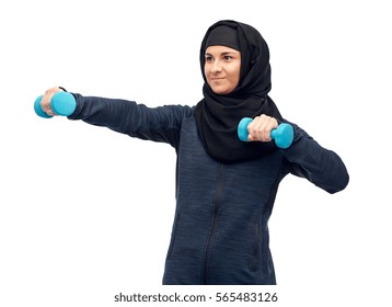 Sport, Fitness And People Concept - Happy Muslim Woman In Hijab With Dumbbells Doing Exercises