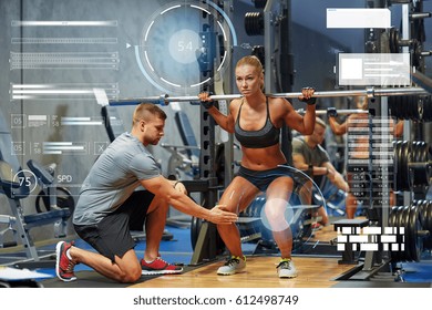 Sport, Fitness, Teamwork, Bodybuilding And People Concept - Young Woman And Personal Trainer With Barbell Flexing Muscles In Gym Over Virtual Charts