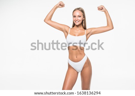 sport fitness woman flexing show her biceps muscles, young smile girl athletic body, perfect figure wear panties isolated over white background