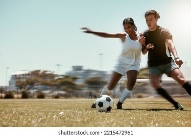 Sport, friends and soccer with man and woman playing on a soccer field, competitive training for sports goal. Fitness, couple and energy with interracial guy and lady having fun with outdoor football - Powered by Shutterstock