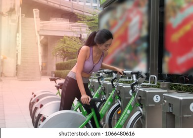 Sport Girl Using Share Bike In The City