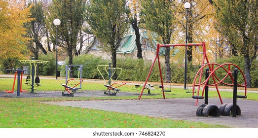 Sport Ground With Various Training Apparatus In Outdoor City Park. Healthy Lifestyle Option In Public Park With Playground, Free Work Out Place Training Facility. Autumn Landscape Scene With No People