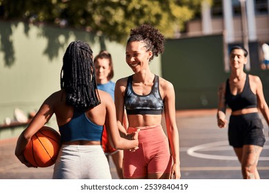 Sport, handshake and women with ball, outdoor and camaraderie of athletes, basketball court and match. Playing, shaking hands and people with respect, cheerful and gesture of sportsmanship and team - Powered by Shutterstock