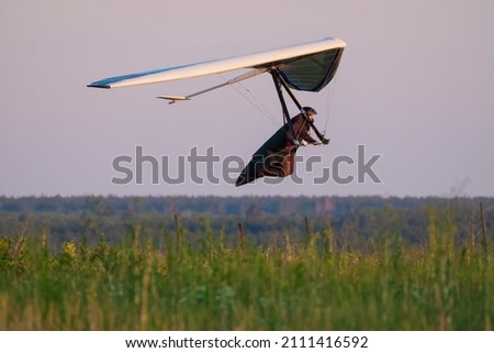 Sport hang glider low above ground. Extreme sports