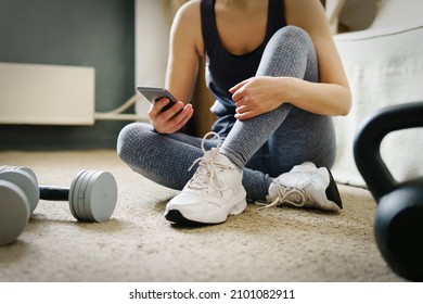 Sport And Healthy Woman After Workout At Home. Using Smartphone To Count Calories. 