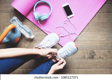 Sport and healthy woman tying her shoes, Workout at home, Wellbeing