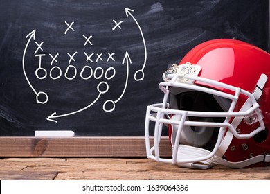 Sport Helmet In Front Of A Chalkboard With Football Play Strategy - Powered by Shutterstock