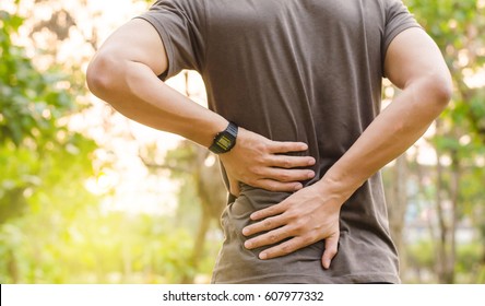 Sport injury, Man with back pain - Shutterstock ID 607977332