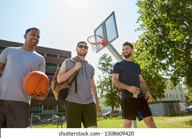 Sport, Leisure Games And Male Friendship Concept - Group Of Men Or Friends Going To Play Basketball Outdoors