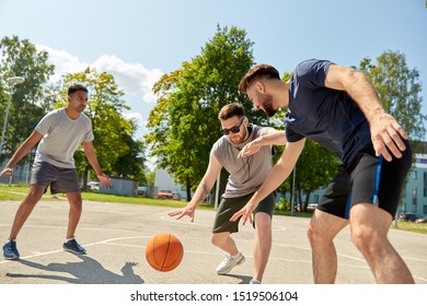 Sport, Leisure Games And Male Friendship Concept - Group Of Men Or Friends Playing Street Basketball