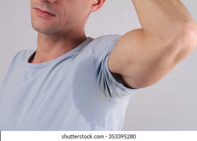 Sport man armpit sweating. Transpiration stain. Hyperthyroidism concept