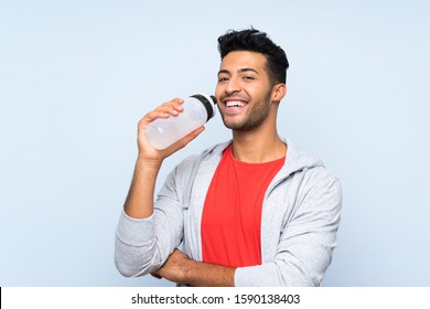 Sport Man With A Bottle Of Water Over Isolated Blue Wall