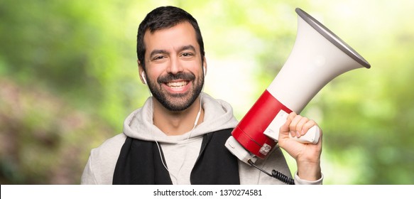 Sport Man Holding A Megaphone In A Park