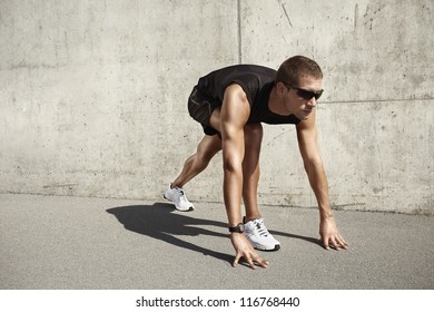 sport man on cement background - Shutterstock ID 116768440