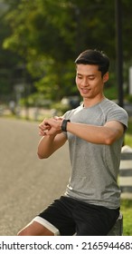 Sport Man Resting And Checking His Heart Rate Data On Smartwatch During Morning Workout In The Park