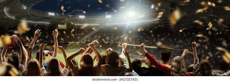 Sport match event. Back view of football fans cheering favorite soccer team at crowded stadium at evening time. Winning championship. Concept of competition, leisure time, emotions, live sport event - Powered by Shutterstock