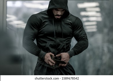 Sport Mind Male Motivation Concept Of Epic Hero Strong Man In Hoodie Preparing For Weight Lifting During Indoor Gym Workout Training