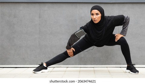 Sport Motivation. Athletic Muslim Lady In Modest Sportswear Stretching Outdoors, Fit Islamic Female Preparing Leg Muscles Before Jogging Outside, Warming Up During Workout, Panorama With Copy Space