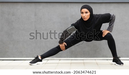 Sport Motivation. Athletic Muslim Lady In Modest Sportswear Stretching Outdoors, Fit Islamic Female Preparing Leg Muscles Before Jogging Outside, Warming Up During Workout, Panorama With Copy Space