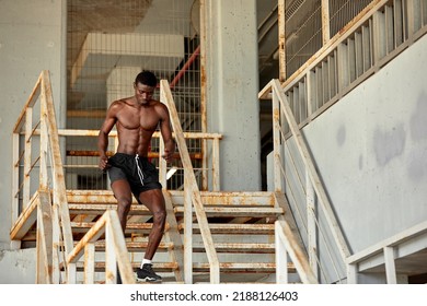 Sport Motivation. Black Male Athlete Running Up On Urban Stairs Outdoors, Enjoying Morning Workout, With Free Space