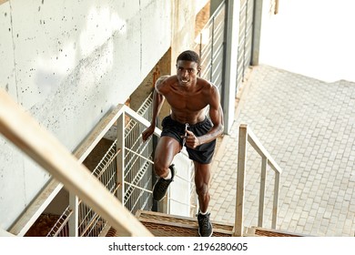 Sport Motivation. Black Male Athlete Running Up On Urban Stairs Outdoors, Enjoying Morning Workout, With Free Space