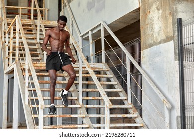 Sport Motivation. Black Male Athlete Running Up On Urban Stairs Outdoors, Enjoying Morning Workout, With Free Space