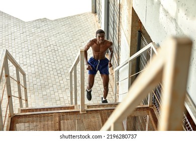 Sport Motivation. Black Male Athlete Running Up On Urban Stairs Outdoors, Enjoying Morning Workout, With Free Space