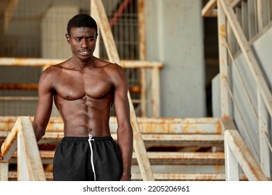 Sport Motivation. Black Male Athlete Running Up On Urban Stairs Outdoors, Enjoying Morning Workout, With Free Space