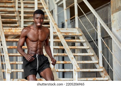 Sport Motivation. Black Male Athlete Running Up On Urban Stairs Outdoors, Enjoying Morning Workout, With Free Space