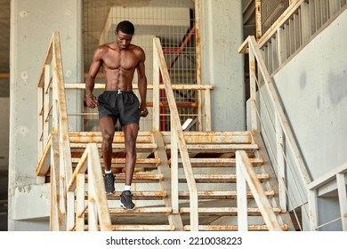 Sport Motivation. Black Male Athlete Running Up On Urban Stairs Outdoors, Enjoying Morning Workout, With Free Space