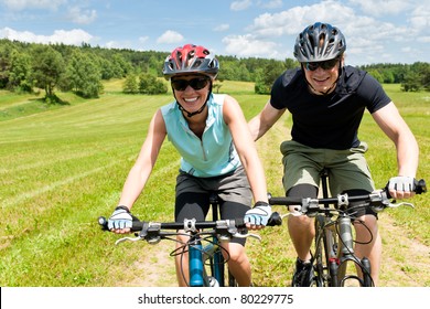 Sport Mountain Biking - Man Pushing Young Girl Uphill Sunny Countryside