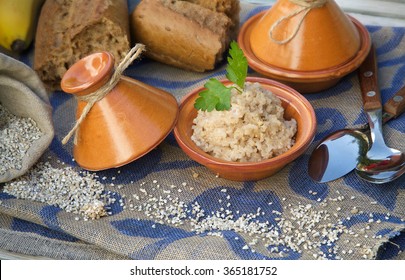 Sport Nutrition: Boiled Barley Cereal. Served In Tajine. Raw Barley Cereal,whole Grain Bread And Spoons In The Background