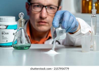 Sport Nutrition Supplement In Lab. Doctor Examines BCAA Powder. Close Up.