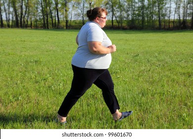 Sport - Overweight Woman Running On Green Meadow