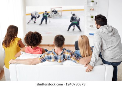 Sport, People And Entertainment Concept - Happy Friends Watching Ice Hockey Game On Projector Screen At Home