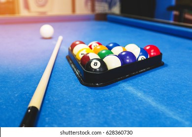 Sport, recreation, game, competition - Playing billiard. Billiards balls an cue on billiards table. Billiard sport concept. Pool billiard game.