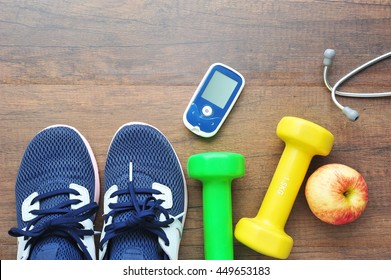 Sport Shoe With Glucose Meter,stethoscope,fruits And Dumbbells For Using In Fitness, Concept Of Diabetes, Exercise In Diabetes Patients Concept.